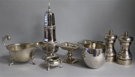 A pair of modern silver pepper mills, a sauceboat, a pair of Continental pedestal salts and three plated items